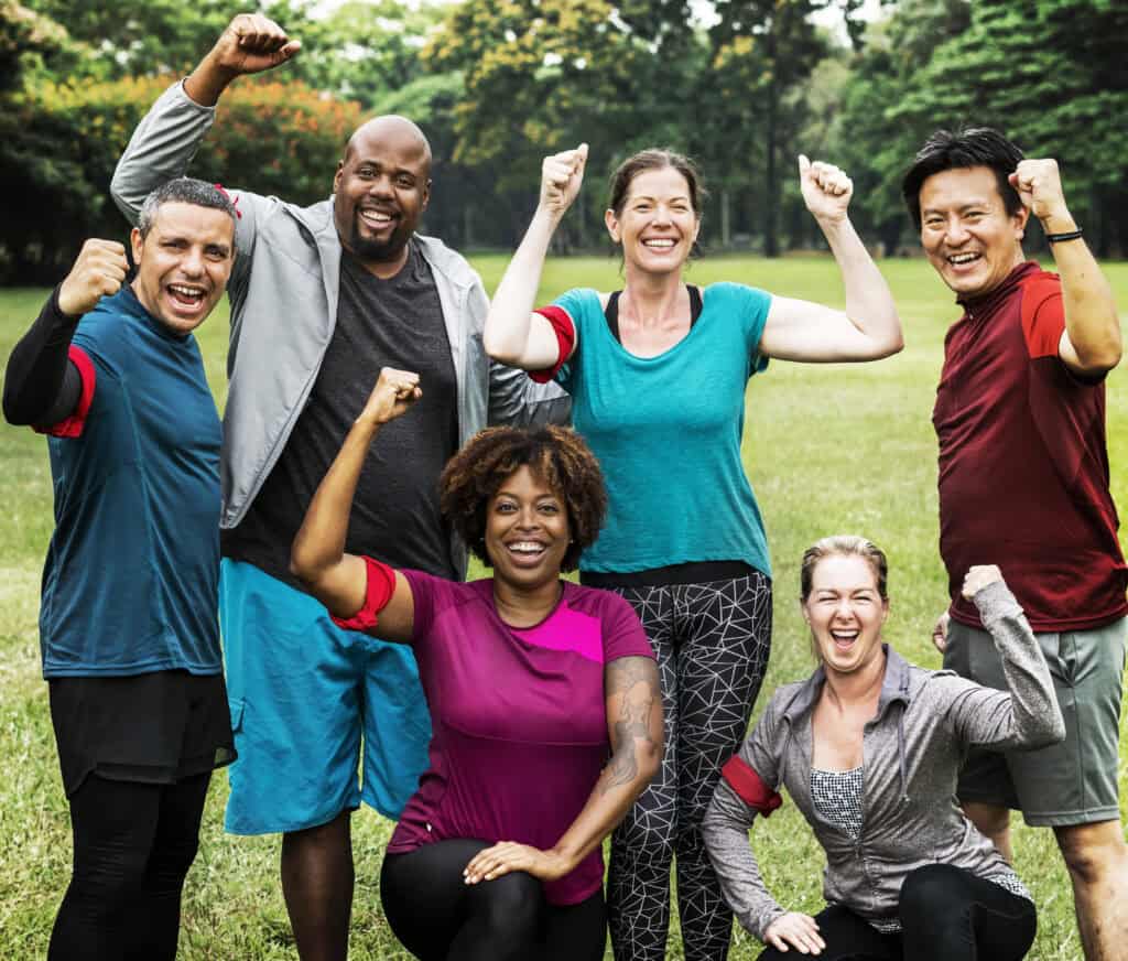 Group of cheerful diverse friends in the park working on their Weight Health 
